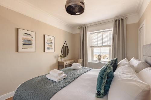 a bedroom with a bed with two towels on it at At Anchor (with a Harbour View) in Fife