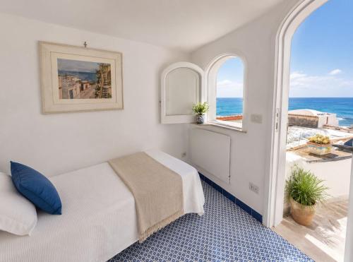 a bedroom with a bed and a view of the ocean at Villa Positano with sea view ! in Positano