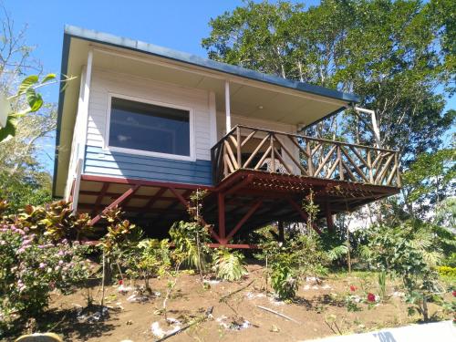 a tiny house with a porch and a balcony at Villas Valle Bello in Ujarrás