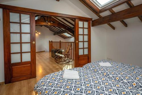 a bedroom with a bed with a blue and white comforter at Chez Lulu in Brézins