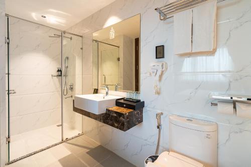 a bathroom with a toilet and a sink and a shower at The Solith Hotel Managed By Nicecy in Ho Chi Minh City