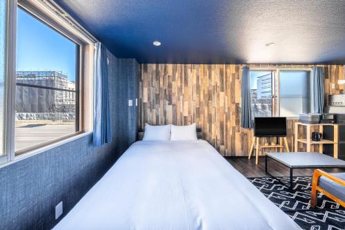 a bedroom with a large bed and a window at Silk Court 201 in Chitose