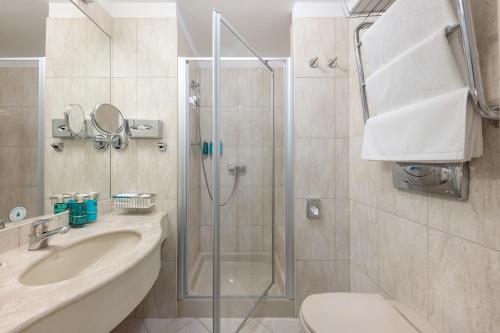 ein Badezimmer mit Dusche, Waschbecken und Toilette in der Unterkunft My City Hotel in Tallinn