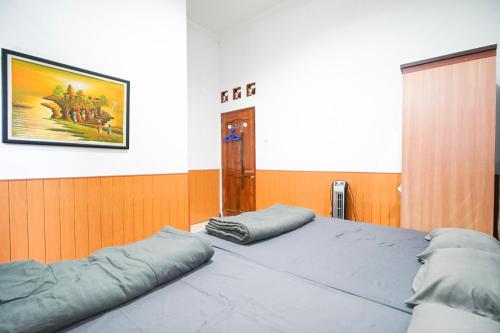a bedroom with two pillows on top of a bed at Ndalem Artho in Beran-kidul