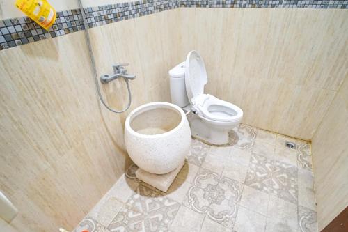 a bathroom with a toilet in a shower stall at Ndalem Artho in Beran-kidul