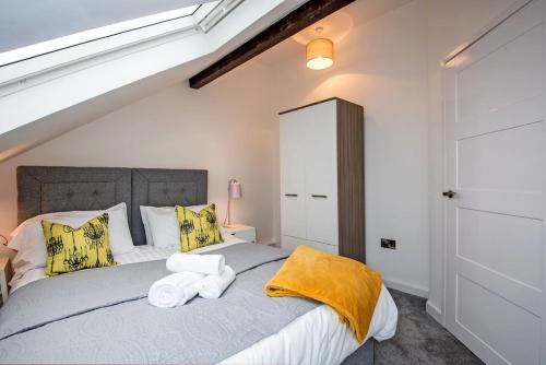 a bedroom with a bed with towels on it at Fifty Two Old Elvet in Durham