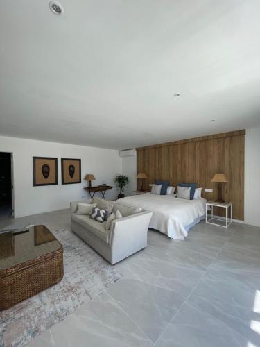 a large bedroom with a bed and a couch at Sotogrande Polo Experience Luxury Villa in Sotogrande