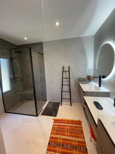 a bathroom with a shower and a sink and a ladder at Sotogrande Polo Experience Luxury Villa in Sotogrande