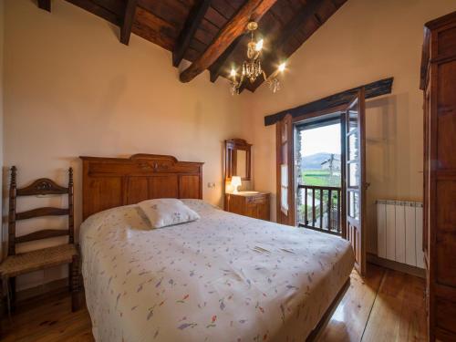 a bedroom with a large bed and a window at Caserio Gaztelu in Gaztelu