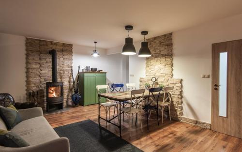 a living room with a table and chairs and a fireplace at Ski apartmán CHOPOK JASNA in Belá