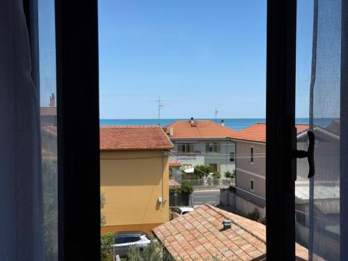 a view of the ocean from a window at SE268 - Marzocca, comodo quadrilocale con garage in Marzocca di Senigallia