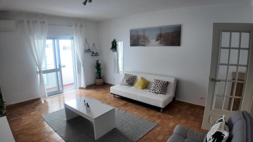 a living room with a couch and a coffee table at Casa Inês in Fuzeta