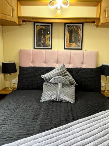 a large bed with two pillows on top of it at Willows Retreat in Reighton