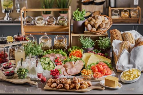 a table filled with lots of different types of food at Smarthotel Bodø in Bodø