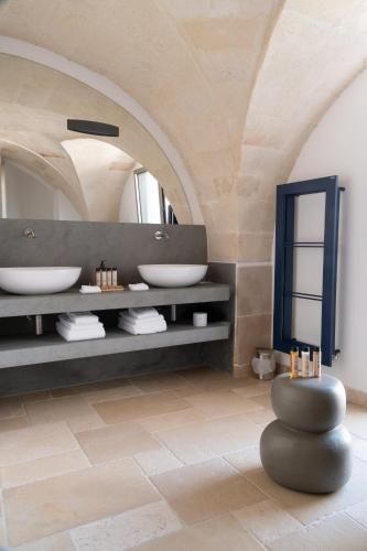 a bathroom with two sinks and a mirror at Dimora Mennuti in Monteparano