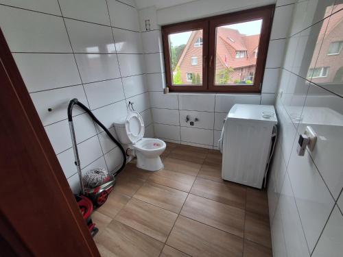 a small bathroom with a toilet and a window at Monteurzimmer KM in Delbrück