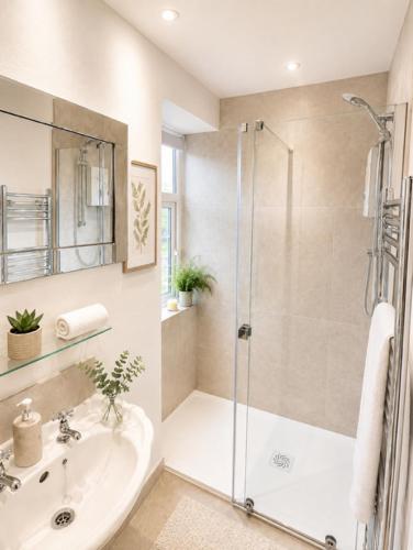 a bathroom with a shower and a sink at Simply the best ! 4 Min walk to Beach, Pubs, Restaurants, Shops, Heated Pool, Hottub, Games room, 1 acre Garden, BBQ's, Private Parking, WIFI, Basesets acre, call for other dates ! in Portreath