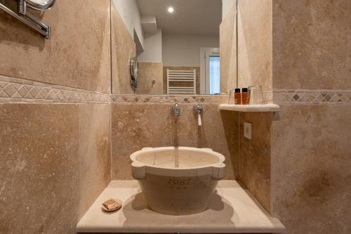 a bathroom with a toilet with a shower in it at Hotel Les Messugues in Saint Paul de Vence