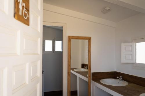 a bathroom with two sinks and a mirror at Cortijo El Solano in Antequera
