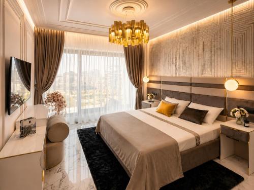 a bedroom with a large bed and a large window at FIRST RESIDENCe in Mamaia