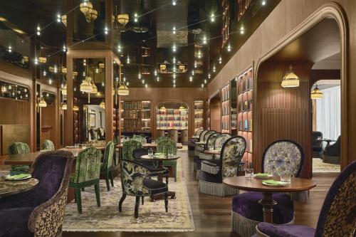 a restaurant with chairs and tables in a library at Maxwell Reserve Singapore, Autograph Collection in Singapore