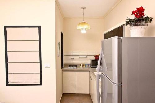a small kitchen with a refrigerator and a counter at Achuza Bamarom in Safed