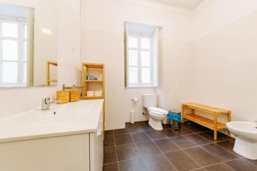 uma casa de banho com um lavatório e um WC em The Palm Leaf - SOC em Lisboa