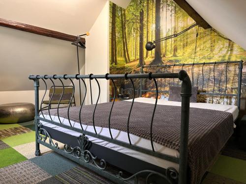 a bed in a room with a painting on the wall at Ferienhaus Ferienwohnung Petermännchen in Westerburg