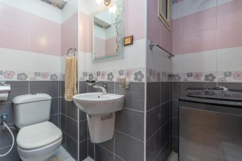 a bathroom with a toilet and a sink at 3BR Beach Front Chalet On RedSea in Ain Sokhna