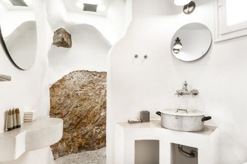 a white bathroom with a sink and a mirror at Timedrops Santorini Villas-Private pool in Emporio