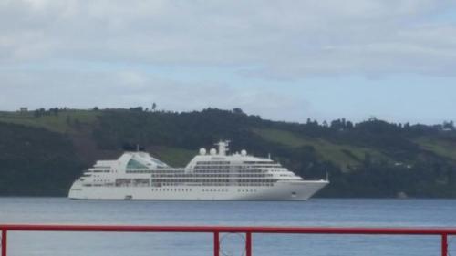 a large cruise ship sitting in the water at Hostal Costa Azul in Castro