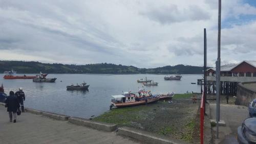 a group of boats in a body of water at Hostal Costa Azul in Castro