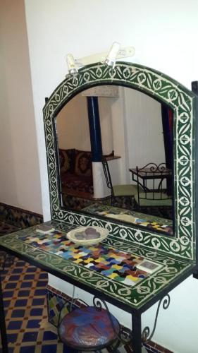 a mirror sitting on top of a table at Dar Ayour appartements in Essaouira