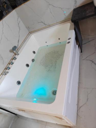 a bath tub filled with water in a bathroom at Hotel Akshara Inn in Nasīrābād