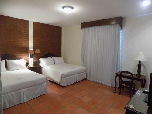 Ein Bett oder Betten in einem Zimmer der Unterkunft Hotel El Convento Leon Nicaragua