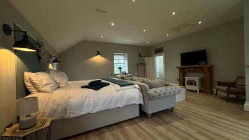 a bedroom with a large bed and a living room at The Loft in Cookstown Junction