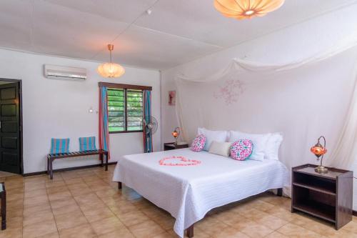 a bedroom with a white bed with pillows on it at Driftwood Beach Malindi Palace in Malindi