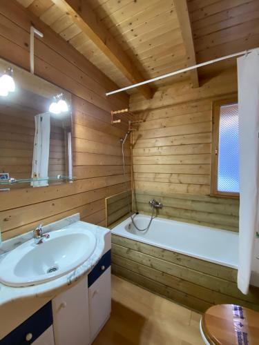 a bathroom with a sink and a bath tub at Camping Aneto in Benasque