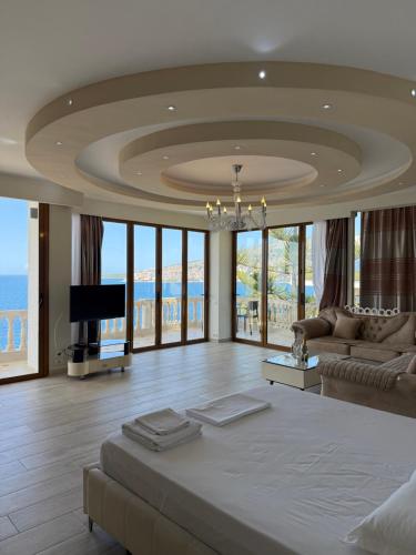 a living room with a large bed and a tv at Apartments Romario in Sarandë