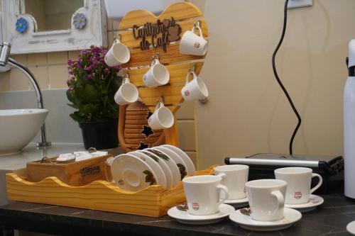 a table with plates and cups on a counter at Hotel Pousada Arco Íris Manaira in João Pessoa