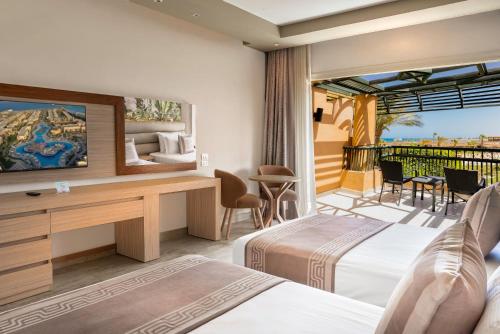 a hotel room with two beds and a balcony at Ali Baba Palace Resort - Families and Couples Only in Hurghada