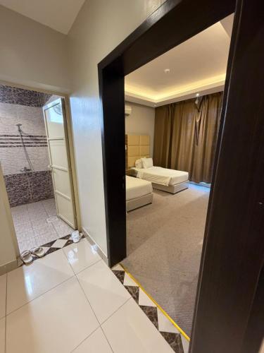 a room with a door open to a bedroom at قلب الشمال للشقق الفندقيه in Hail