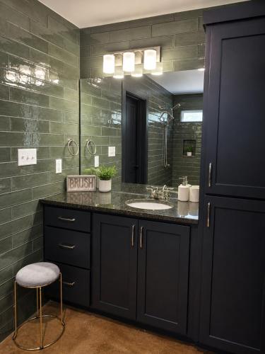 a bathroom with a sink and a mirror at Toad-Ally Cozy Cottage - Conway Getaway in Conway