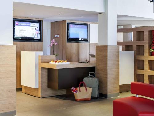 a lobby with a counter with fruit on it at ibis Berlin Dreilinden in Kleinmachnow
