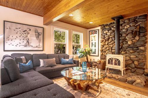 a living room with a couch and a stone wall at Red Elephant | 4BR - Fire Pit - River & Downtown in Hailey