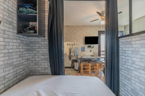 a bedroom with a bed and a living room at L'Elan in Les Angles