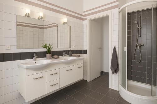 a white bathroom with a sink and a shower at Monteur- und Ferienunterkunft Ludwigsfelde in Ludwigsfelde