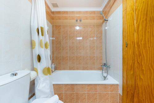 a bathroom with a white tub and a toilet at Villa Patrick in Torrevieja