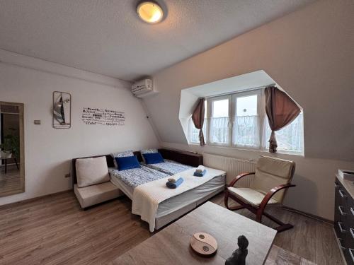 a bedroom with a bed and a table and chairs at Magaslak in Balatonalmádi