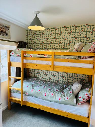 two bunk beds in a room with a lamp at sinton House in Bransford